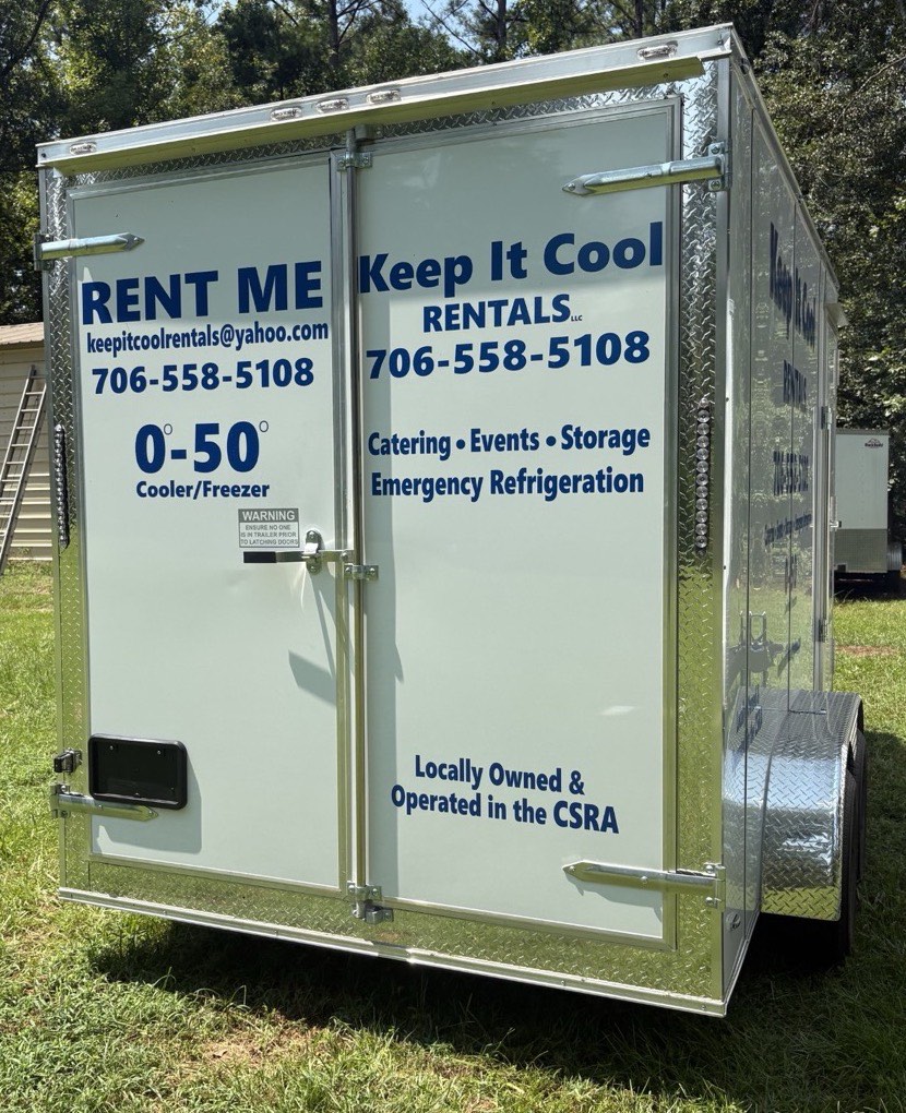 Rear view of a Keep It Cool refrigerated rental trailer showing RENT ME signage, phone number, and the 0 to 50 degree cooler and freezer range