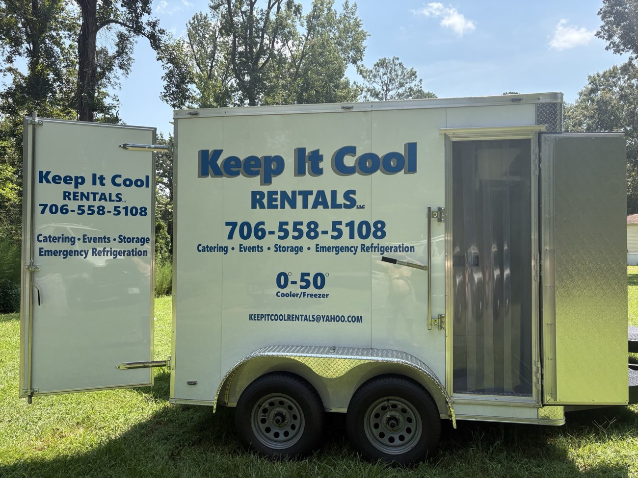 Side view of the 7 by 10 foot Keep It Cool refrigerated rental trailer with its side door open